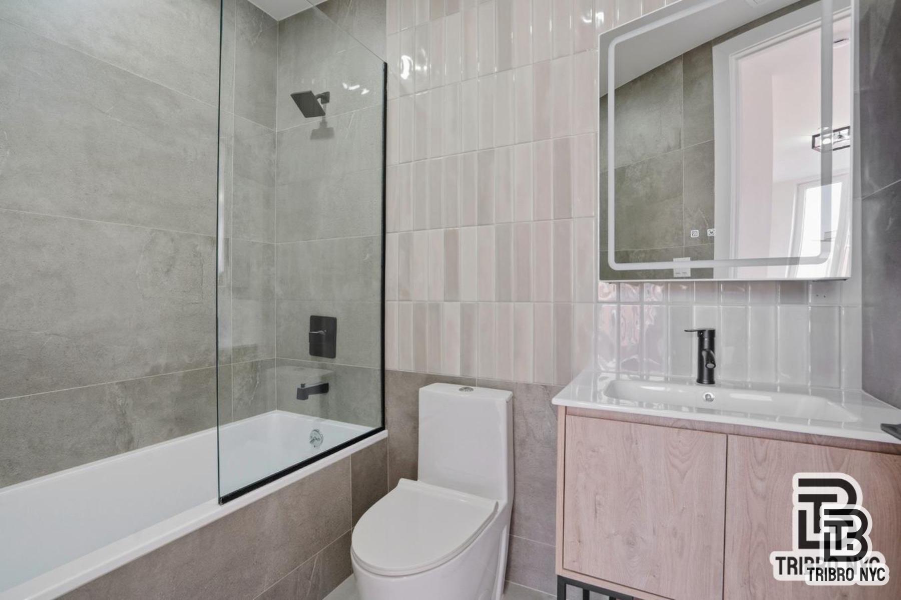 96 Moore Street, Unit 2R Brooklyn, NY 11206 - Photo 7 of 8 a bathroom with a sink a toilet and shower