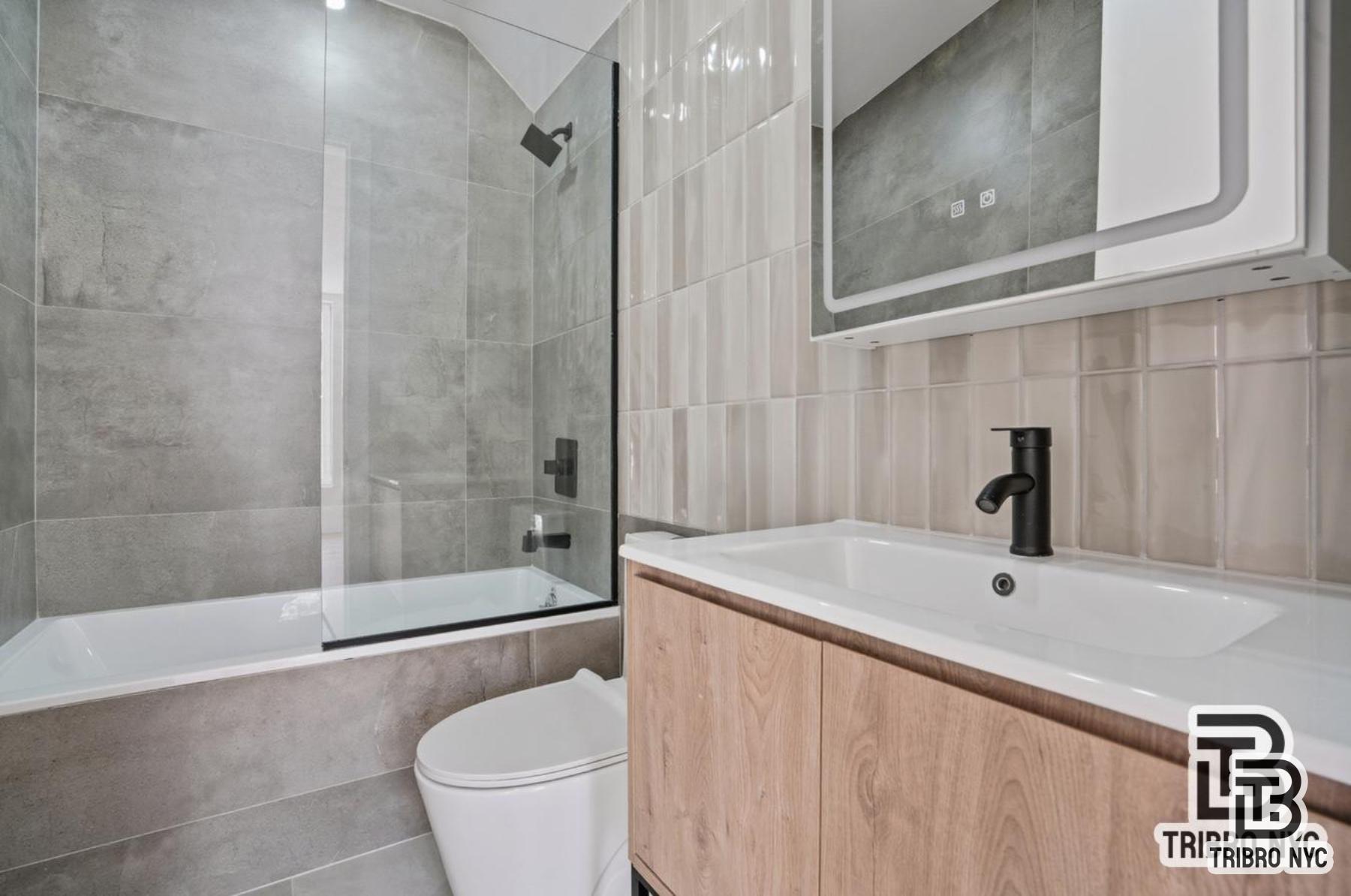 96 Moore Street, Unit 2R Brooklyn, NY 11206 - Photo 8 of 8 a bathroom with a sink a toilet and shower