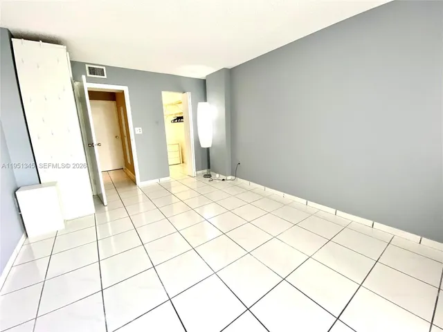 a bedroom with a bed and a mirror