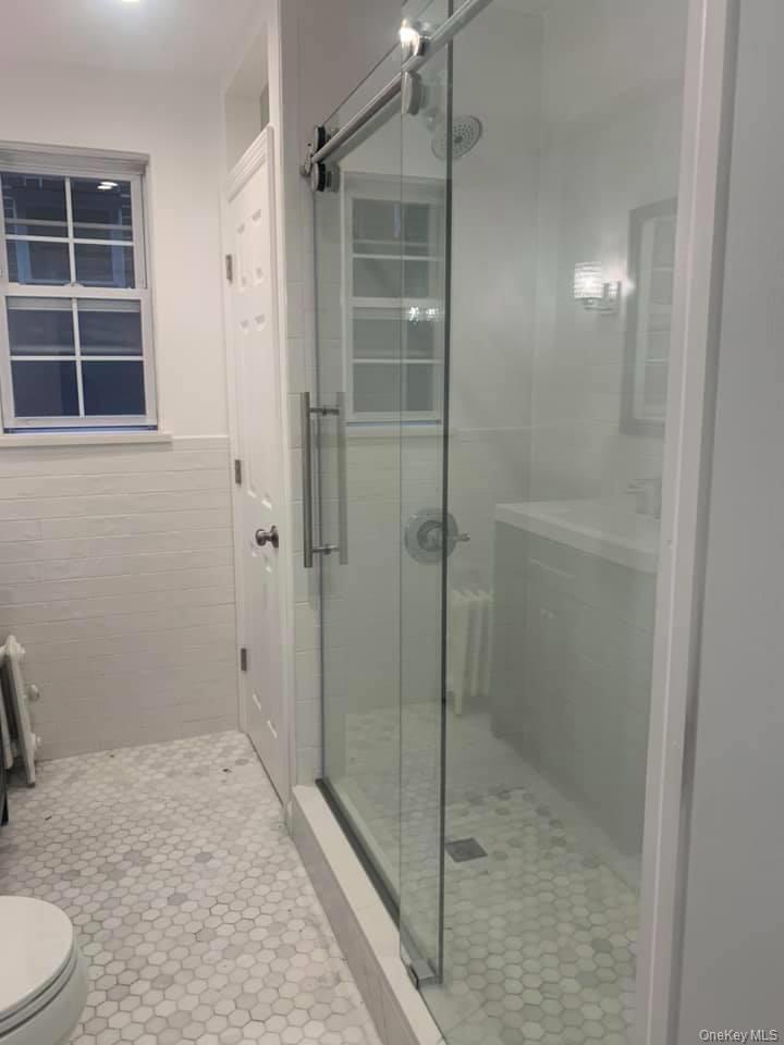 33-26 83rd Street Queens, NY 11372 - Photo 12 of 18 a bathroom with a shower and toilet