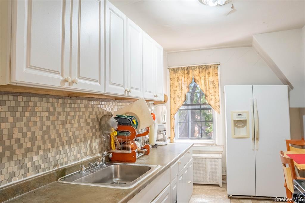 33-26 83rd Street Queens, NY 11372 - Photo 13 of 18 a kitchen with granite countertop a sink and a window