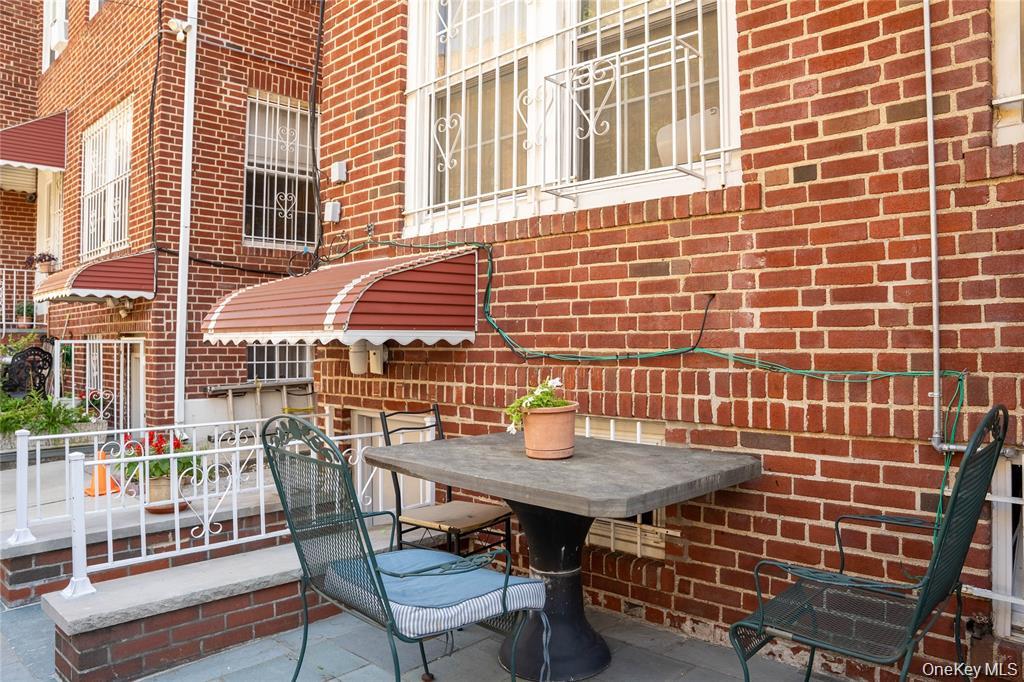 33-26 83rd Street Queens, NY 11372 - Photo 18 of 18 a backyard of a house with barbeque oven table and chairs