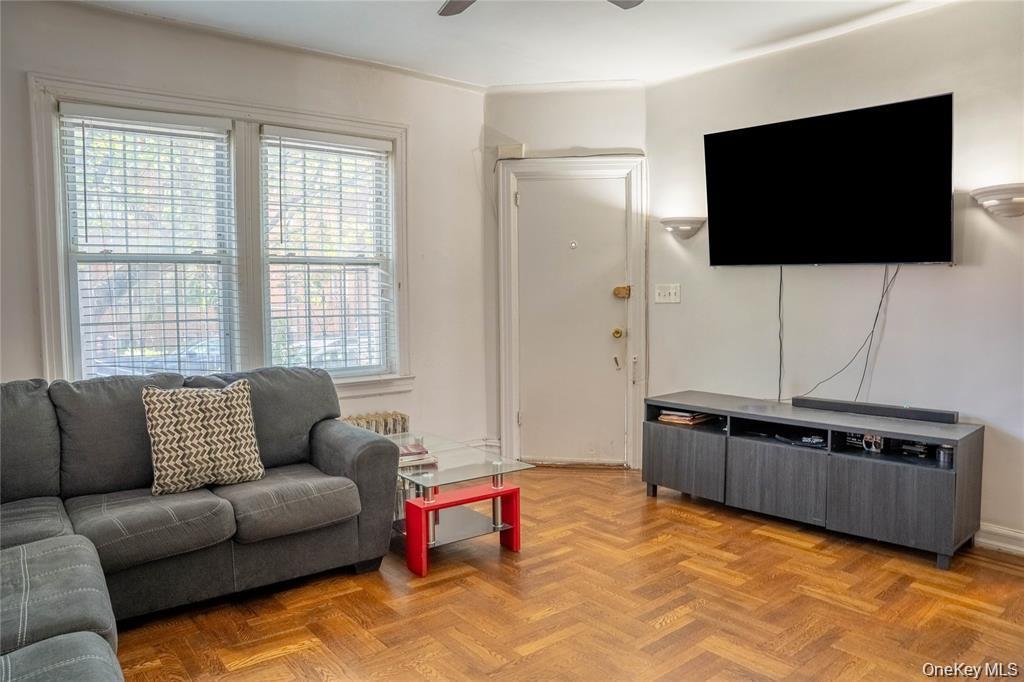 33-26 83rd Street Queens, NY 11372 - Photo 3 of 18 a living room with furniture and a flat screen tv