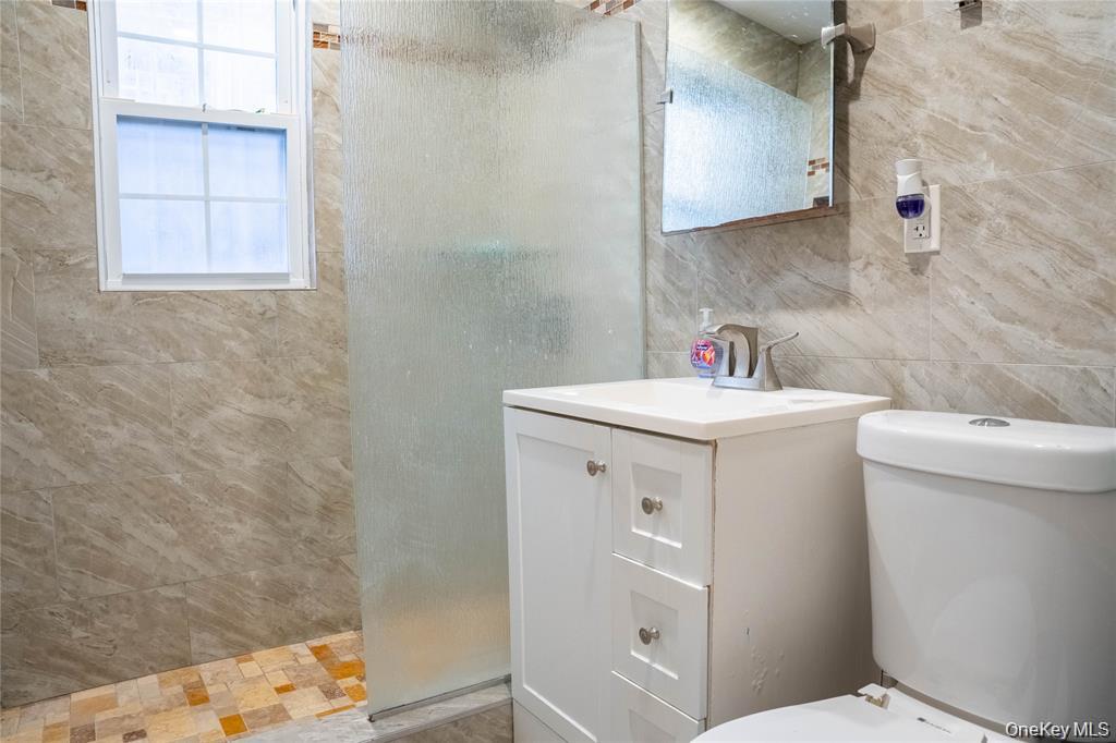 33-26 83rd Street Queens, NY 11372 - Photo 7 of 18 a utility room with a sink a washer and dryer