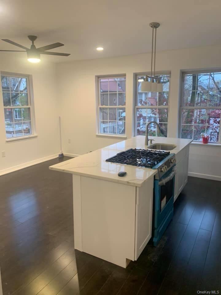 33-26 83rd Street Queens, NY 11372 - Photo 8 of 18 a kitchen that has a sink stainless steel appliances a counter tops and a window