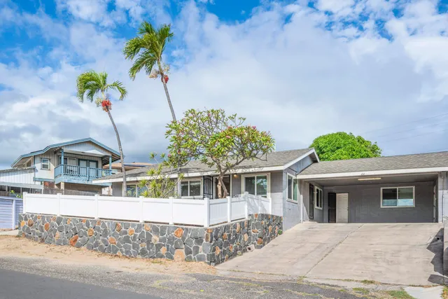 an aerial view of residential houses with yard and parking