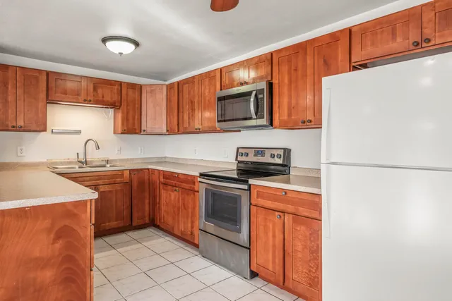 a kitchen with stainless steel appliances granite countertop a sink and cabinets