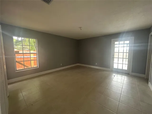 an empty room with windows and entrance