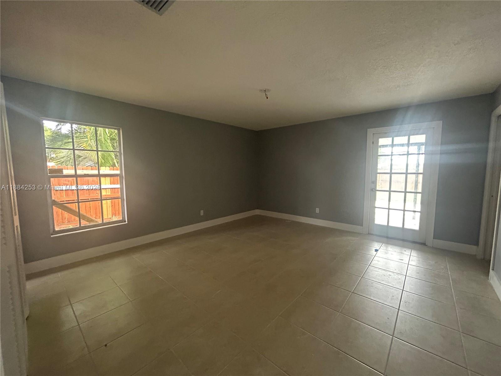 7109 Santa Rosa Parkway Fort Pierce, FL 34951 - Photo 6 of 11 an empty room with windows and entrance