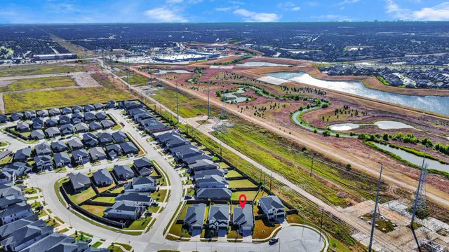 an aerial view of a swimming pool patio and mountain view in back