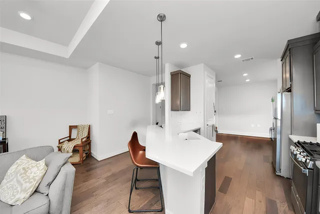 a kitchen with cabinets a sink and chairs
