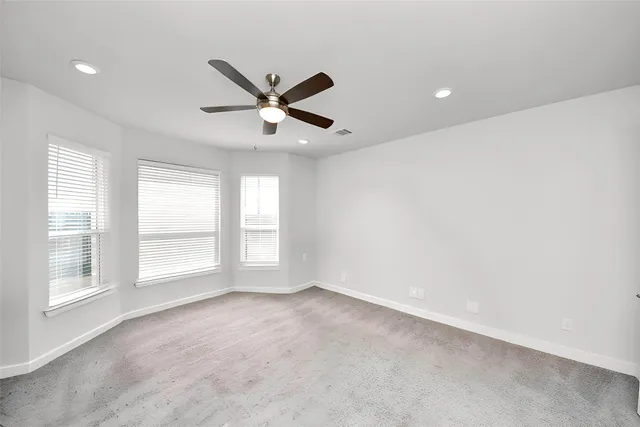 a view of a livingroom with a ceiling fan and window