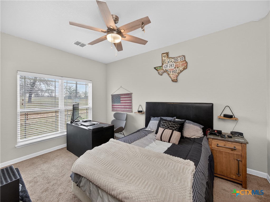 494 Flash Circle Luling, TX 78648 - Photo 26 of 44 a bedroom with furniture and a large window
