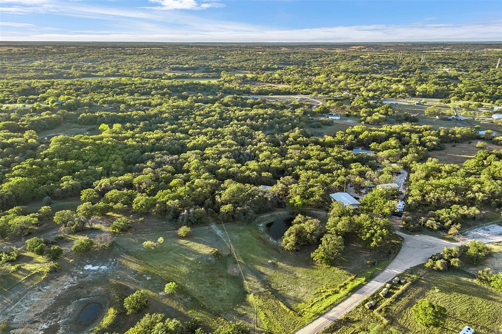 199 Cheyenne Trail Springtown, TX 76082 - Photo 21 of 22 Expansive land parcel featuring dense tree coverage, open grassy areas, and visible water features