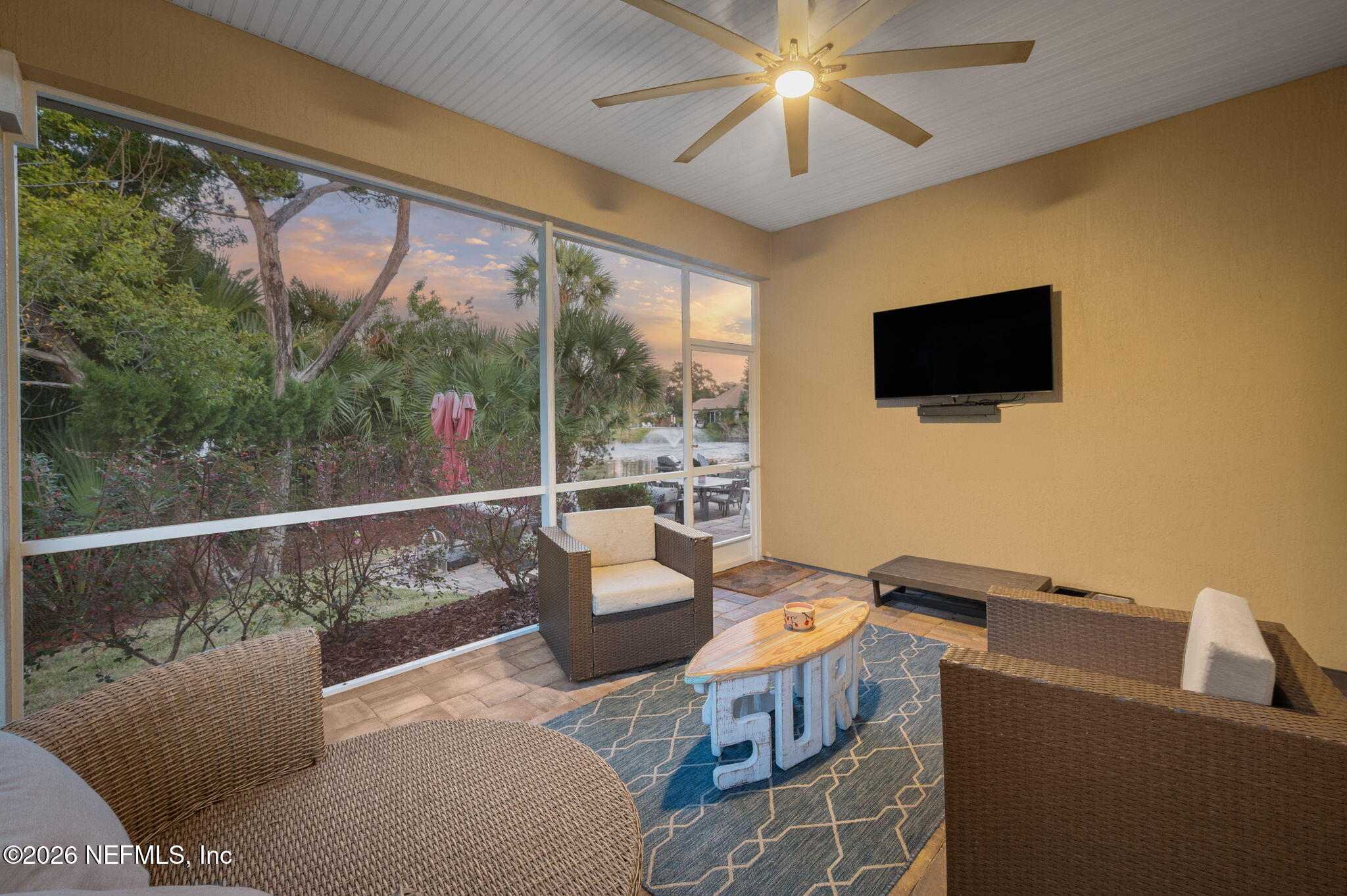 115 Spoonbill Point Court St. Augustine, FL 32080 - Photo 41 of 50 a living room with furniture a flat screen tv and a floor to ceiling window