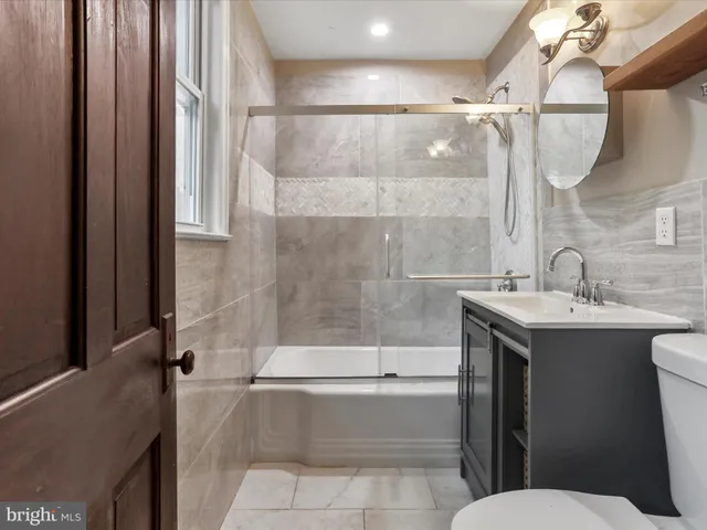 a bathroom with a sink mirror toilet and bathtub