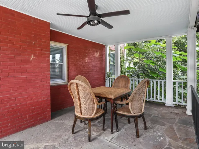a view of a patio with a table chairs and a backyard