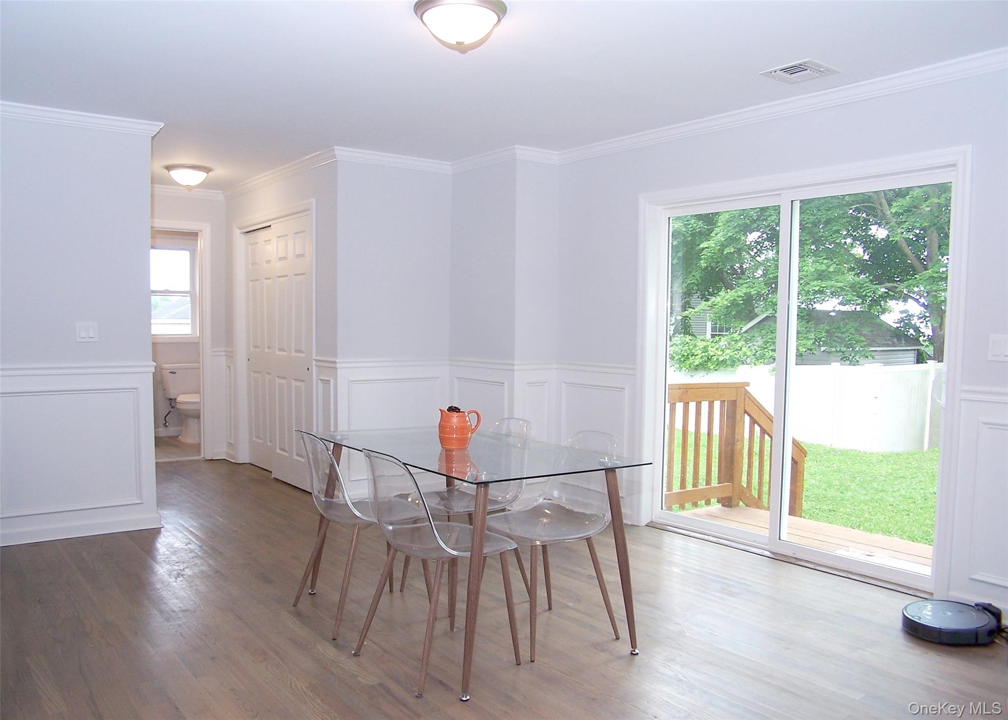 8 Narcissus Road Mastic Beach, NY 11951 - Photo 11 of 20 a view of a dining room with furniture window and wooden floor