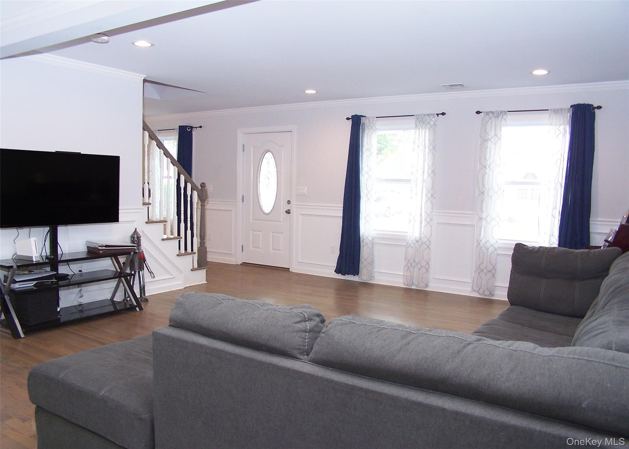 8 Narcissus Road Mastic Beach, NY 11951 - Photo 12 of 20 a living room with furniture and a flat screen tv