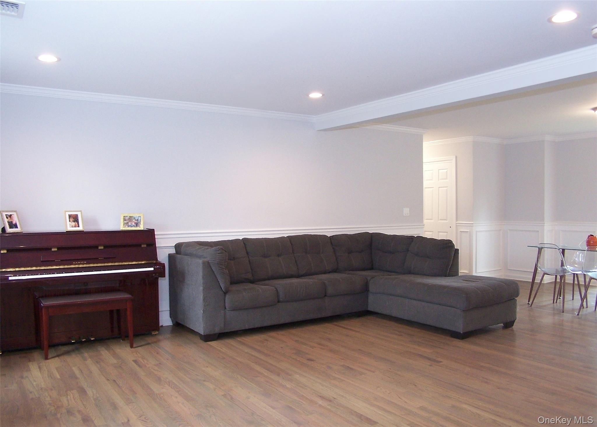 8 Narcissus Road Mastic Beach, NY 11951 - Photo 14 of 20 a living room with furniture and a piano