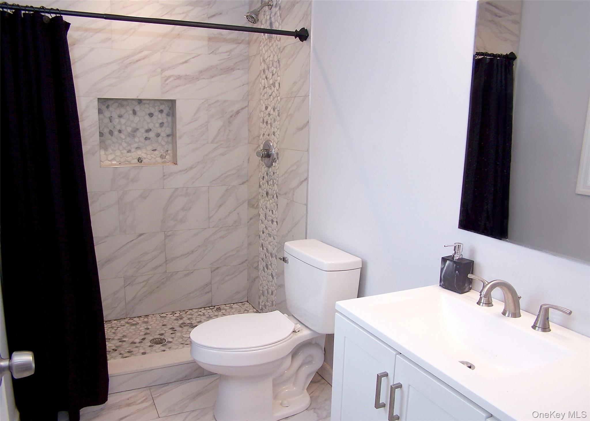 8 Narcissus Road Mastic Beach, NY 11951 - Photo 17 of 20 a bathroom with a sink and a toilet