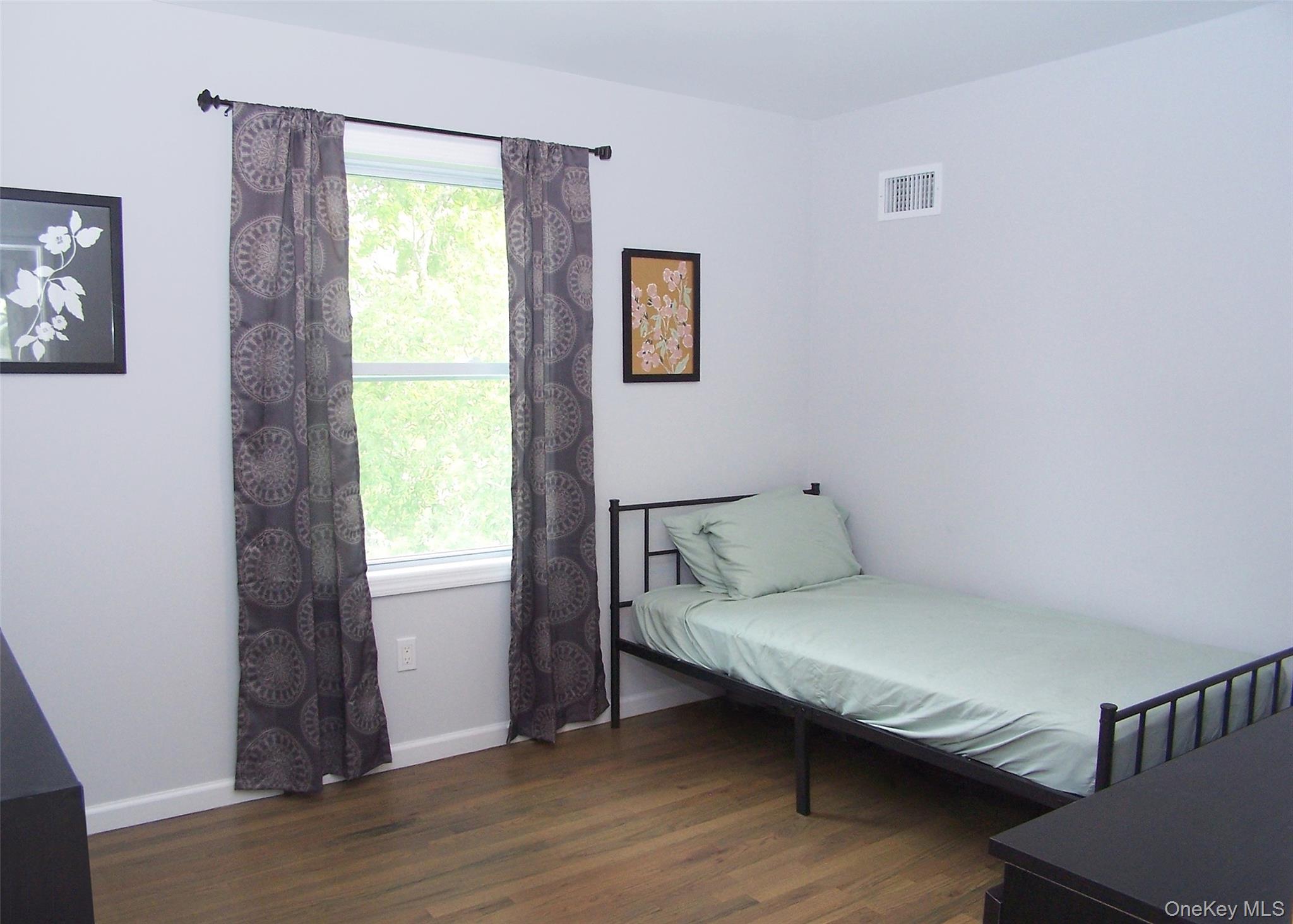 8 Narcissus Road Mastic Beach, NY 11951 - Photo 19 of 20 a bedroom with a bed and a window