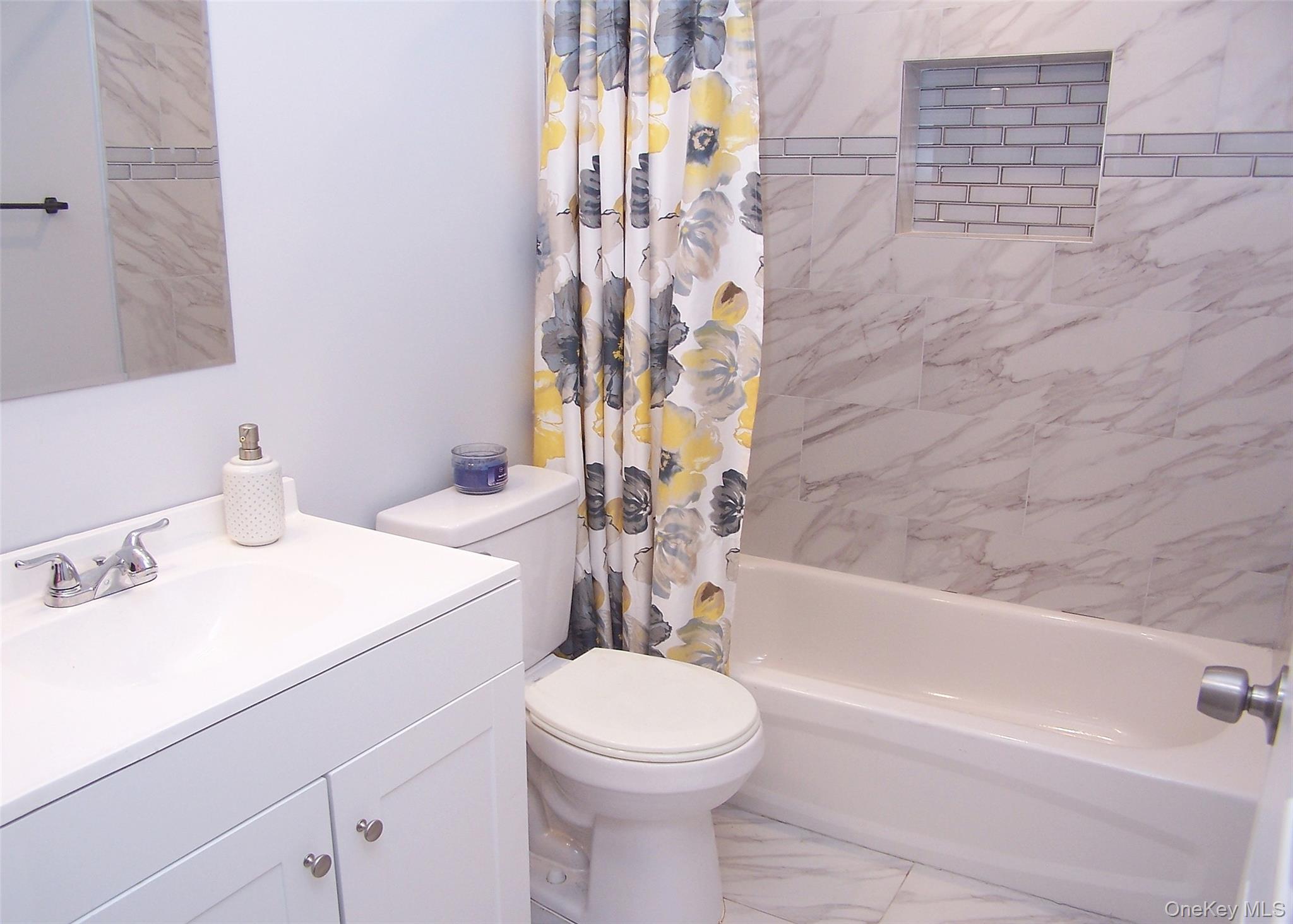 8 Narcissus Road Mastic Beach, NY 11951 - Photo 20 of 20 a bathroom with a sink a toilet and a bathtub