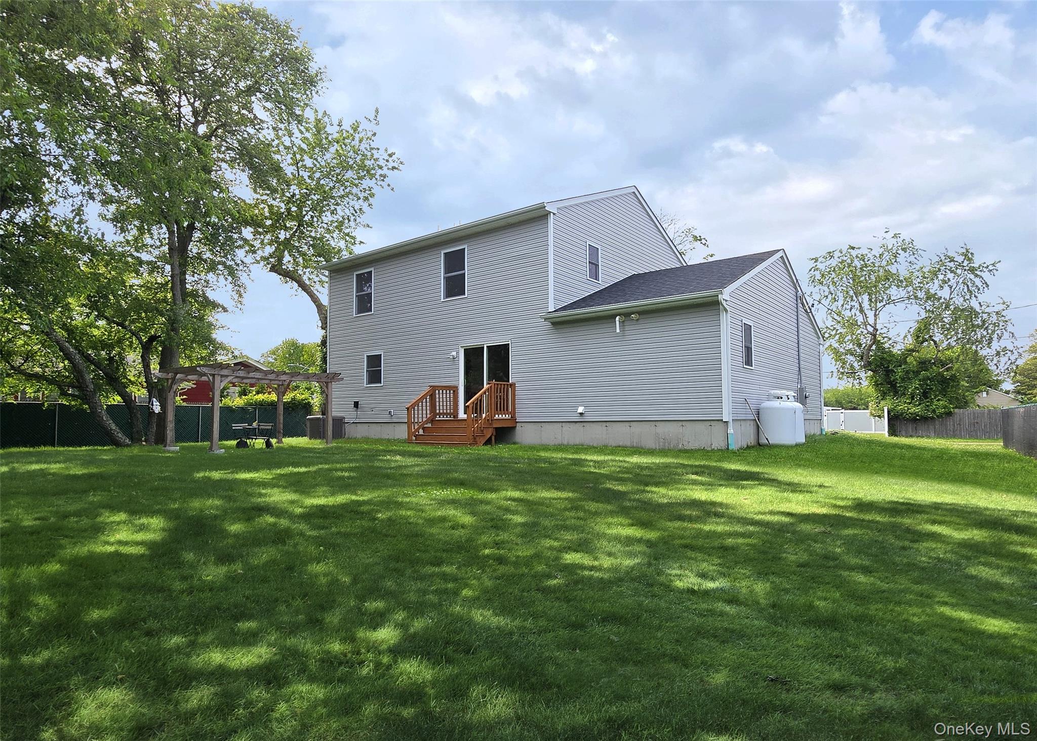 8 Narcissus Road Mastic Beach, NY 11951 - Photo 2 of 20 a front view of house with yard and trees