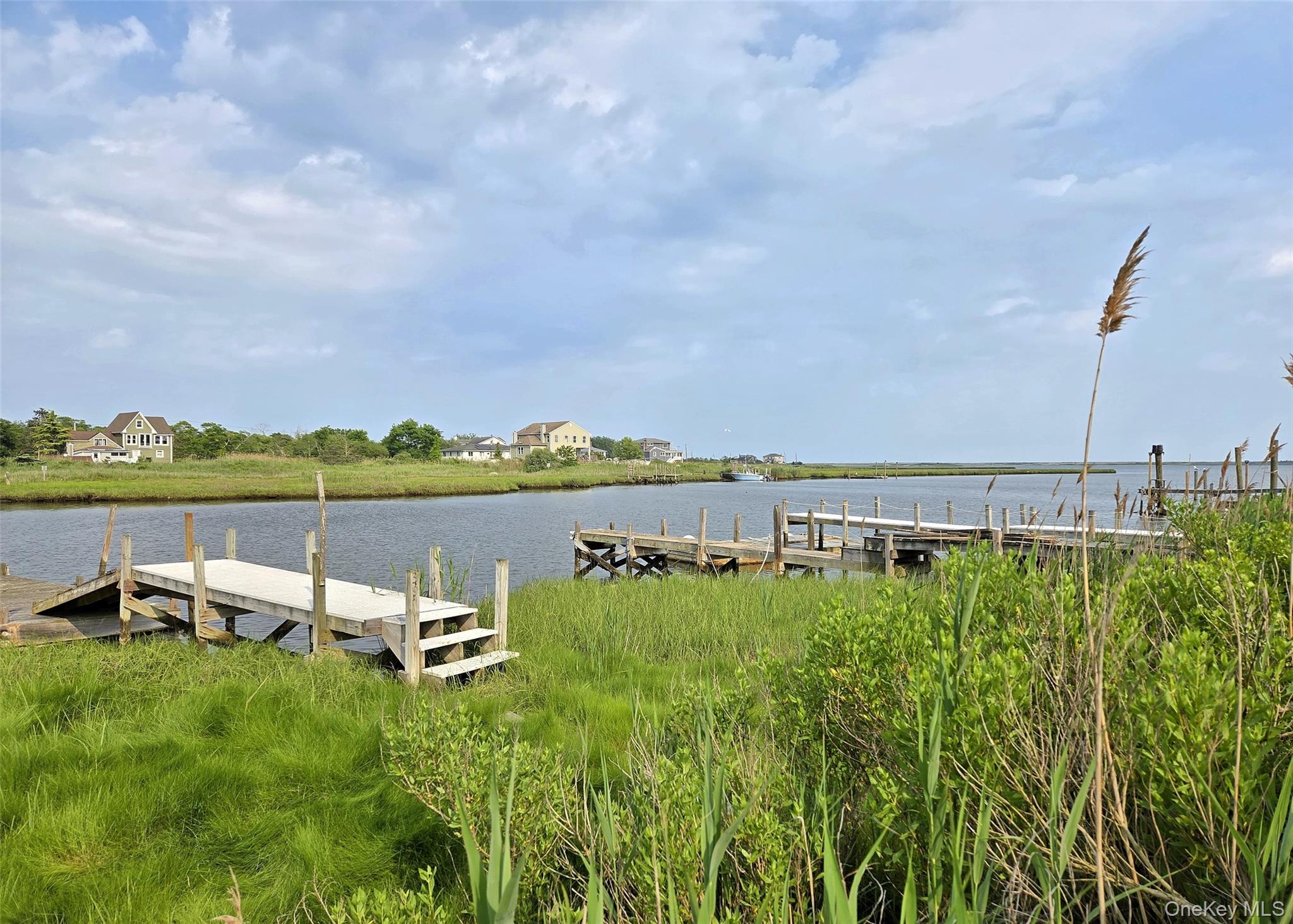 8 Narcissus Road Mastic Beach, NY 11951 - Photo 3 of 20 a view of a lake with houses in the back