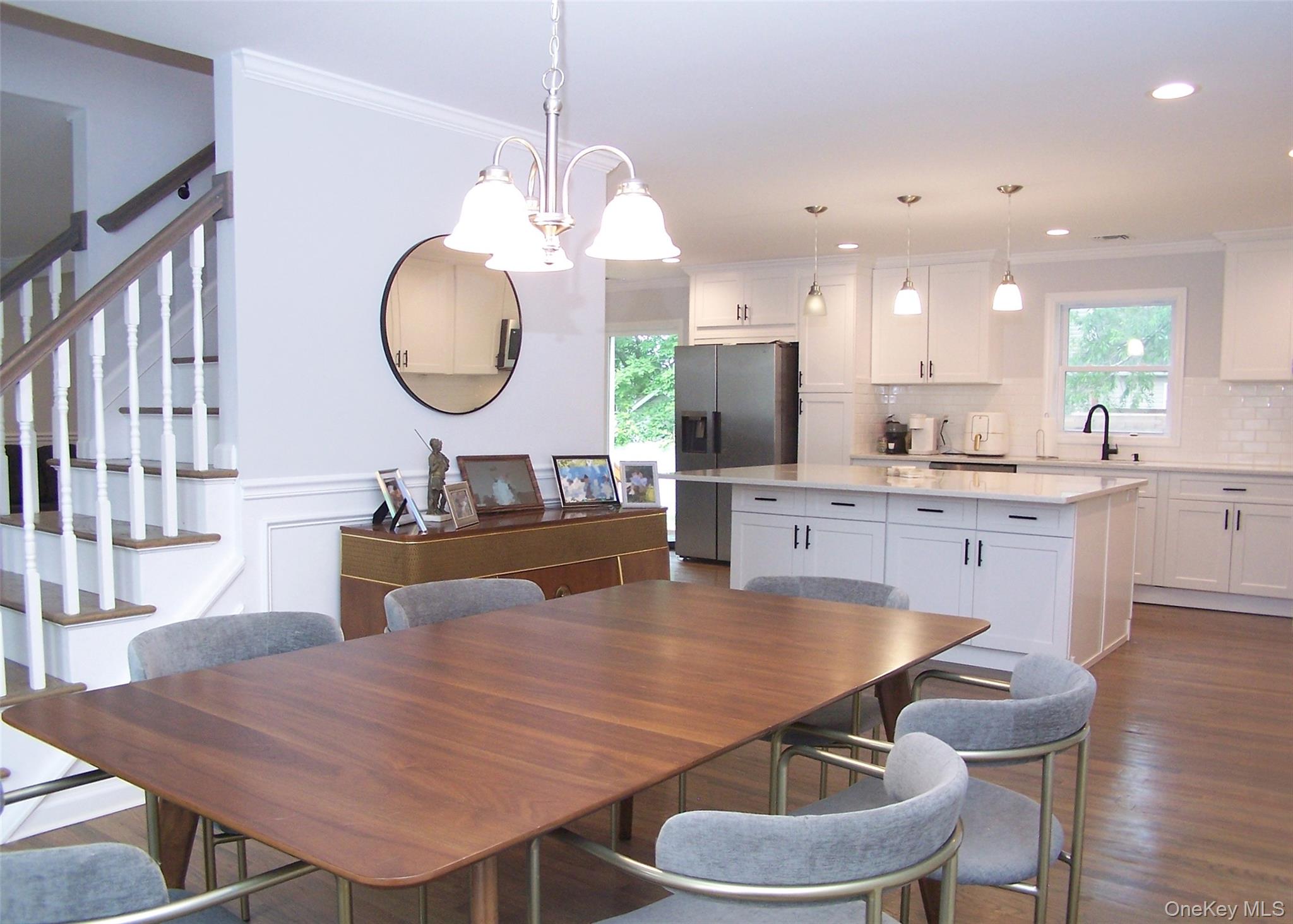 8 Narcissus Road Mastic Beach, NY 11951 - Photo 5 of 20 a large kitchen with a table and chairs