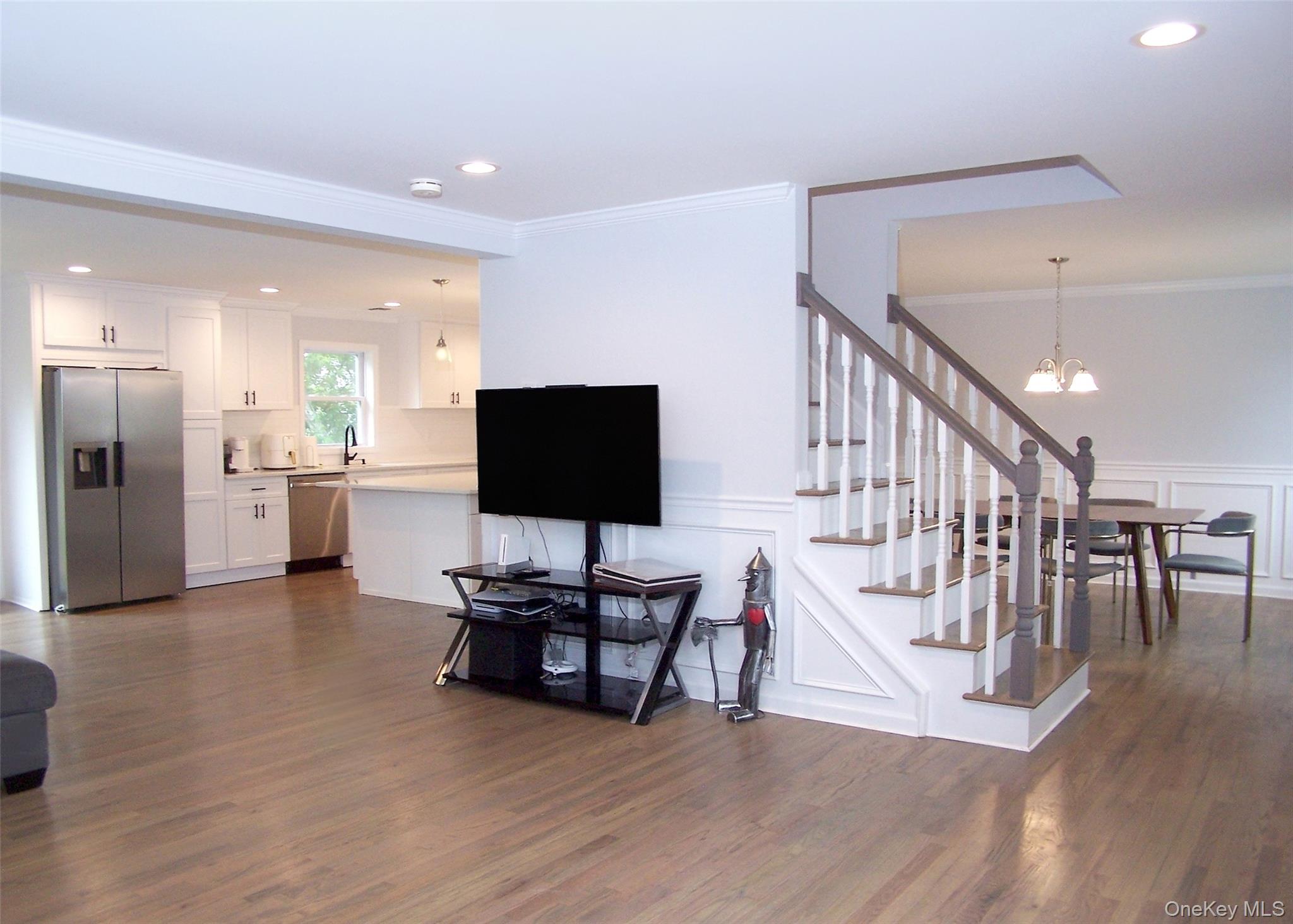 8 Narcissus Road Mastic Beach, NY 11951 - Photo 6 of 20 a living room with furniture and a flat screen tv