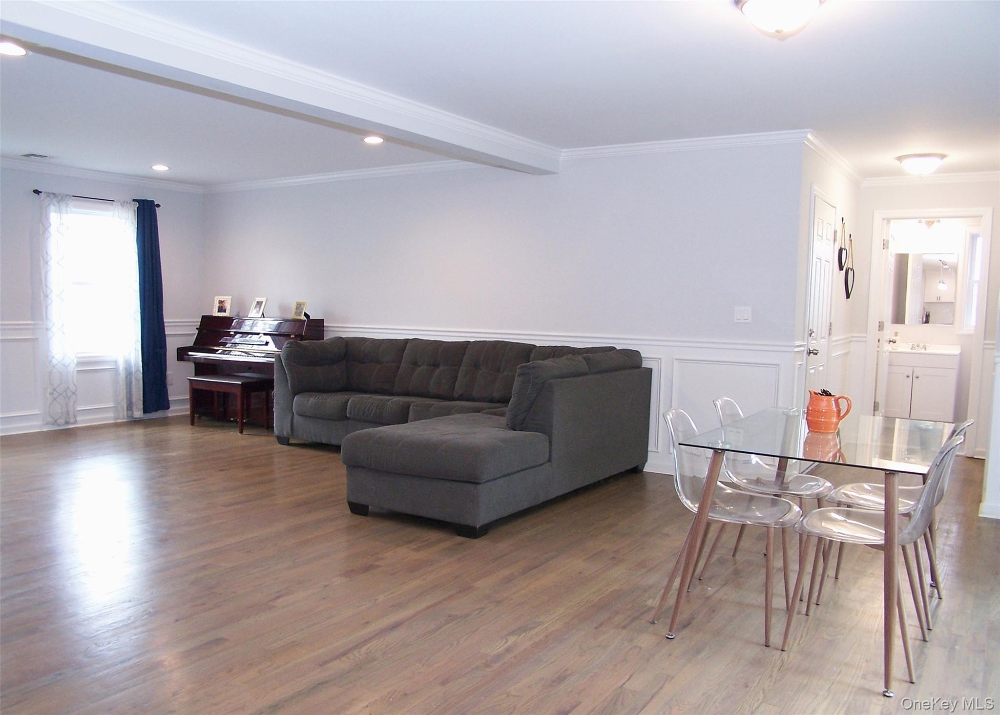 8 Narcissus Road Mastic Beach, NY 11951 - Photo 7 of 20 a living room with furniture and wooden floor