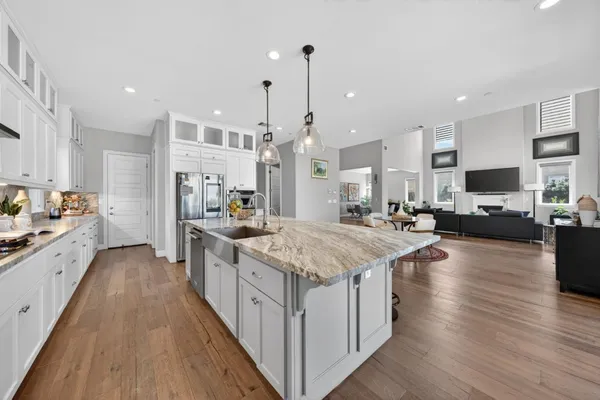 a kitchen with stainless steel appliances granite countertop a sink stove and cabinets