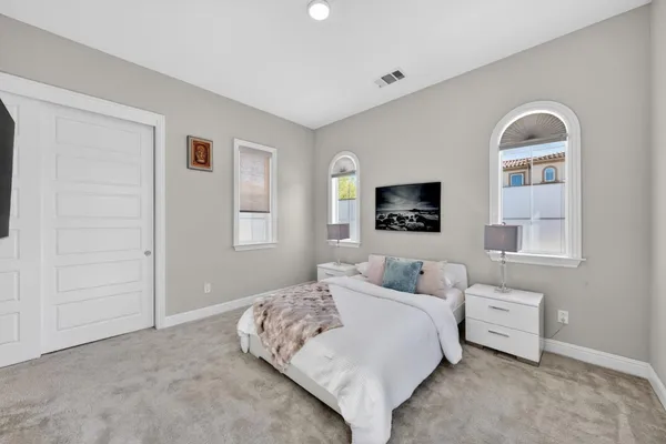 a bed room with a bed and a large window