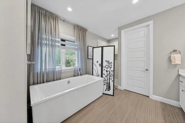 a bathroom with a sink double vanity granite tub and shower
