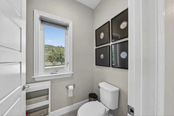 a white toilet sitting next to a bath tub