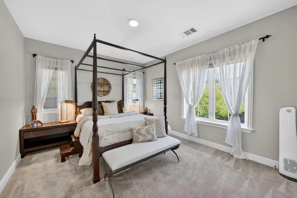 a bedroom with a bed and a desk