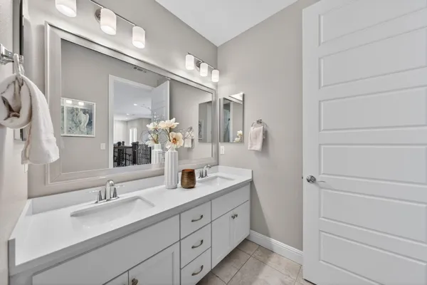 a front view of a house with a yard and potted plants