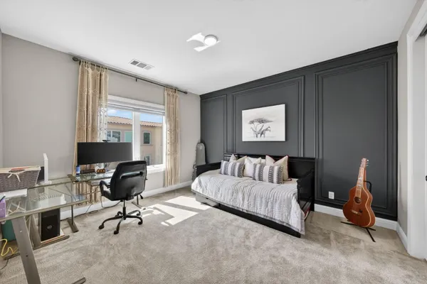 a view of a patio with a table and chairs under an umbrella