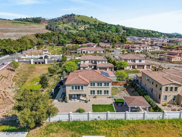 an aerial view of residential houses with yard