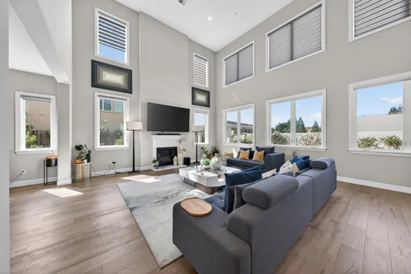 a living room with fireplace furniture and a flat screen tv