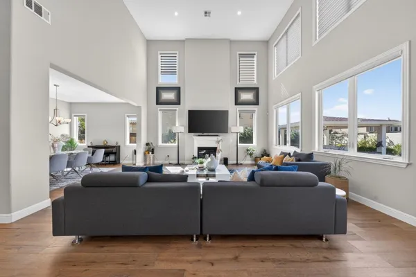 a living room with fireplace furniture and a chandelier