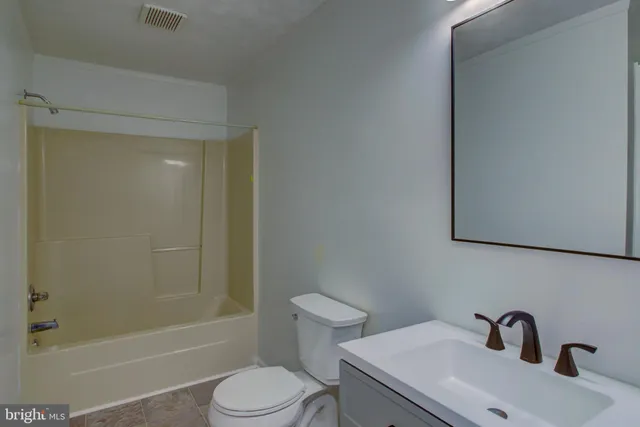 an empty room with wooden floor and closet