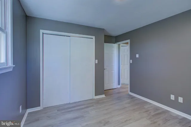 a bathroom with a granite countertop toilet sink and mirror