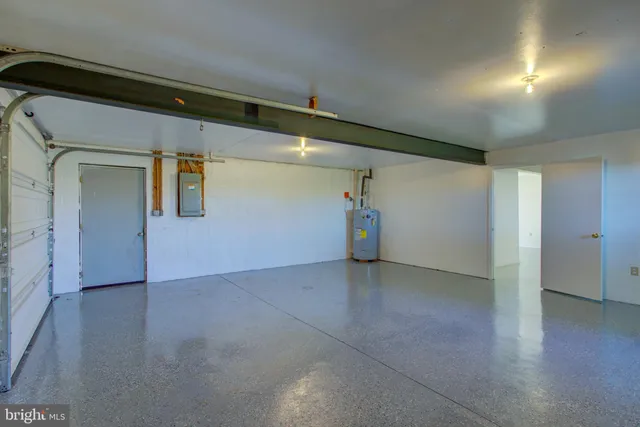 a front view of a house with a garden and trees