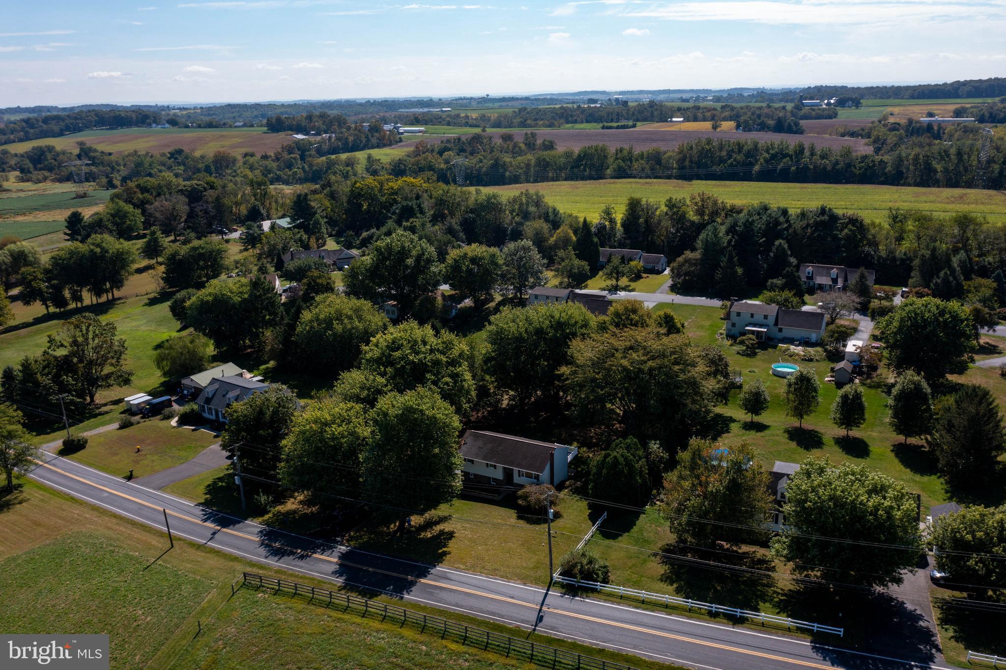 2891 Newport Road Manheim, PA 17545 - Photo 46 of 56 an aerial view of a house with a garden and lake view