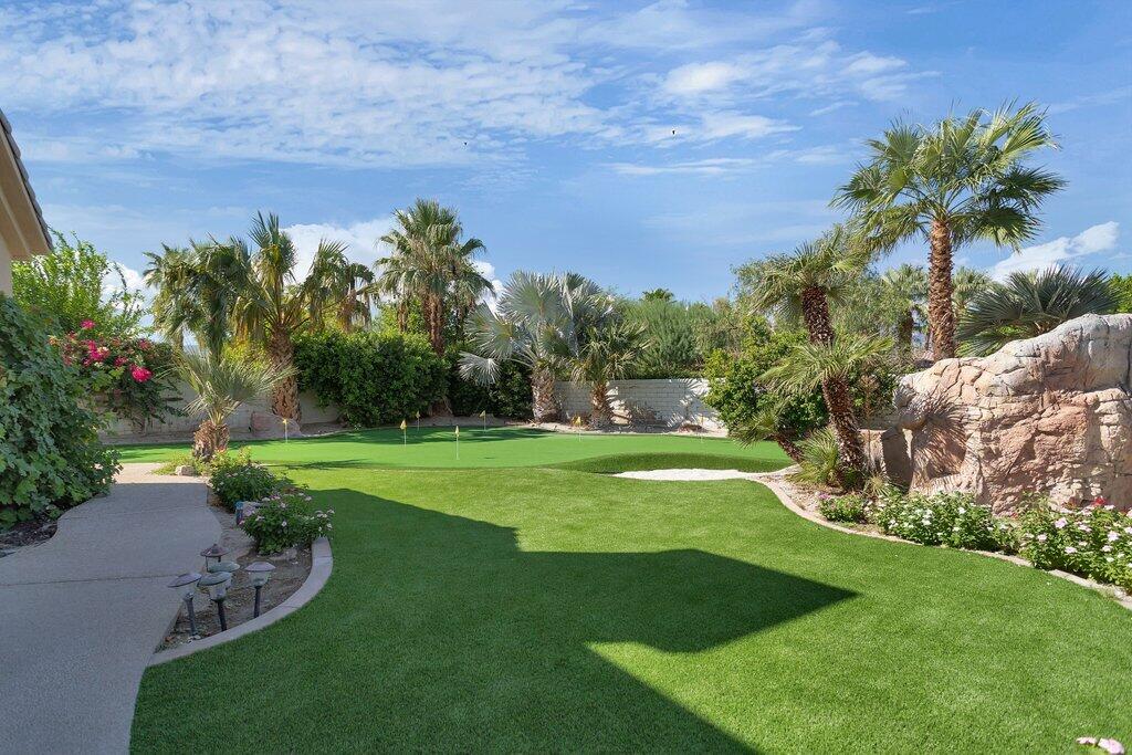 8 MacBeth Court Rancho Mirage, CA 92270 - Photo 37 of 46 a view of a garden with a building in the background