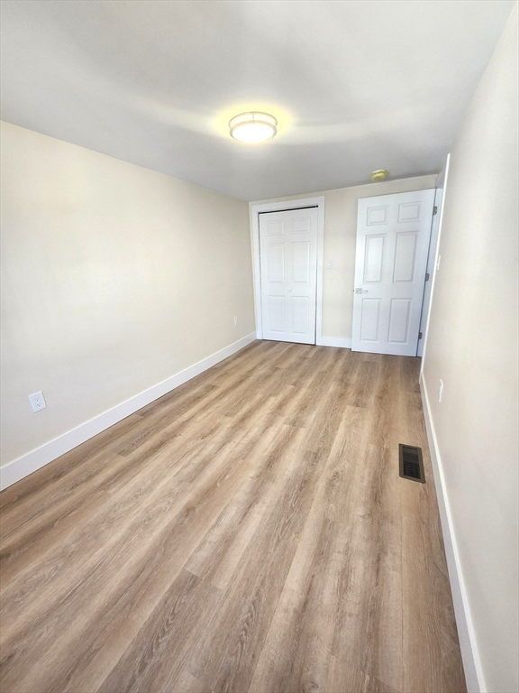 264 Bowen Street, Unit 264 Boston, MA 02127 - Photo 11 of 18 a view of an empty room and wooden floor