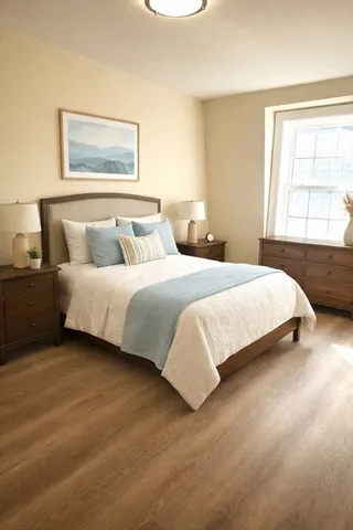 a bedroom with a bed and a large window