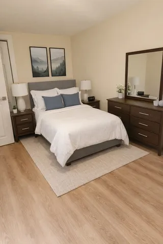 a bedroom with a bed and a dresser